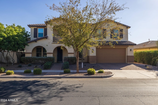 mediterranean / spanish-style house with a garage