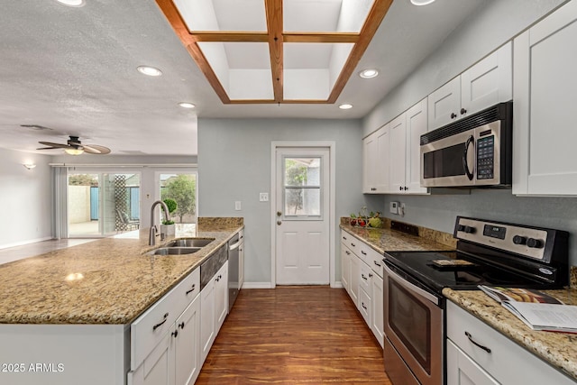 100 E Geneva Dr, Tempe, AZ 85282 - kitchen featuring stainless steel appliances, a sink, a peninsula, recessed lighting, and white cabinets