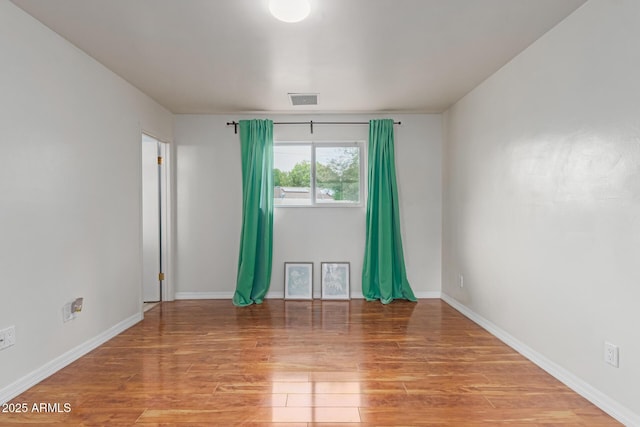 100 E Geneva Dr, Tempe, AZ 85282 - unfurnished room with wood finished floors and baseboards