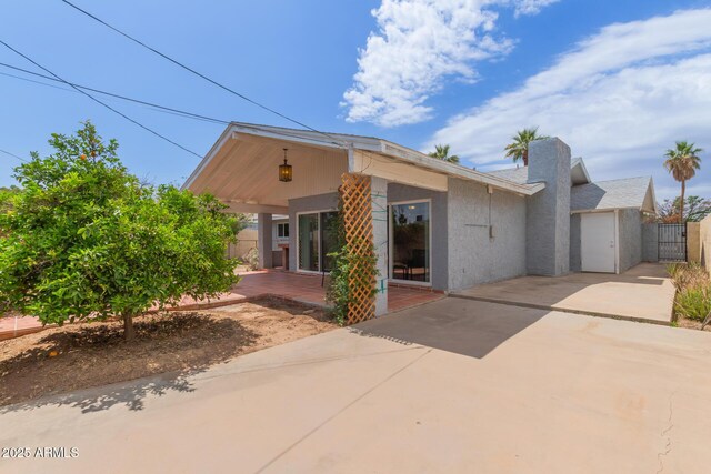 100 E Geneva Dr, Tempe, AZ 85282 - back of house with a patio, stucco siding, driveway, a gate, and fence