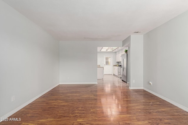 100 E Geneva Dr, Tempe, AZ 85282 - unfurnished living room with wood finished floors and baseboards