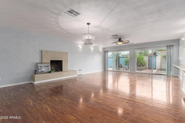 100 E Geneva Dr, Tempe, AZ 85282 - unfurnished living room with wood-type flooring, a ceiling fan, a fireplace with raised hearth, baseboards, and a textured ceiling