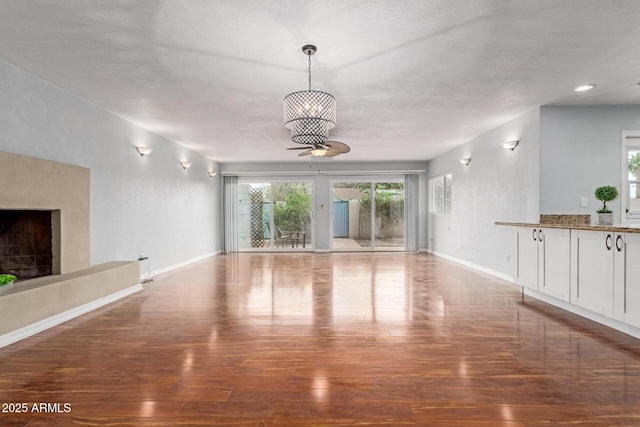 100 E Geneva Dr, Tempe, AZ 85282 - unfurnished living room with wood finished floors, baseboards, and a fireplace with raised hearth