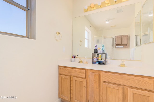 bathroom with an enclosed shower and vanity