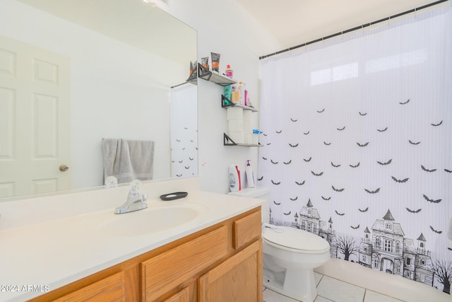 bathroom featuring tile patterned floors, vanity, and toilet