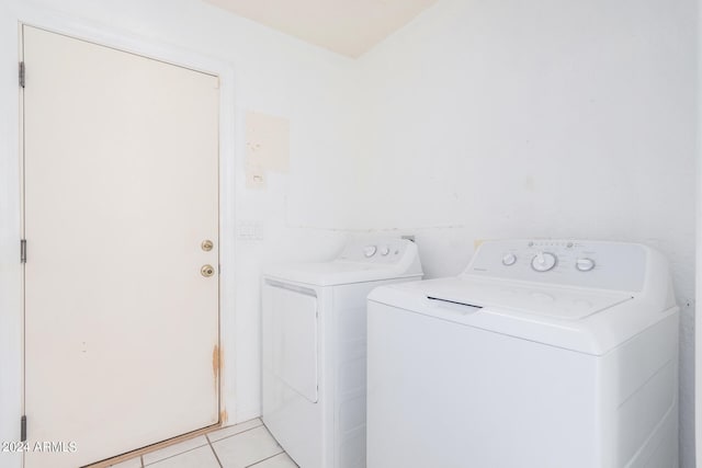 laundry area featuring washer and clothes dryer and light tile patterned floors