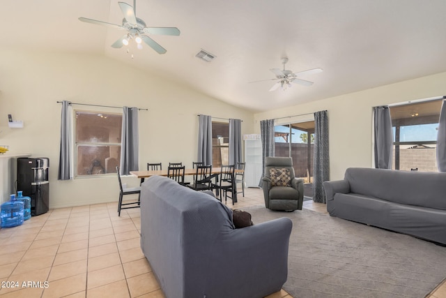 tiled living room featuring ceiling fan and vaulted ceiling