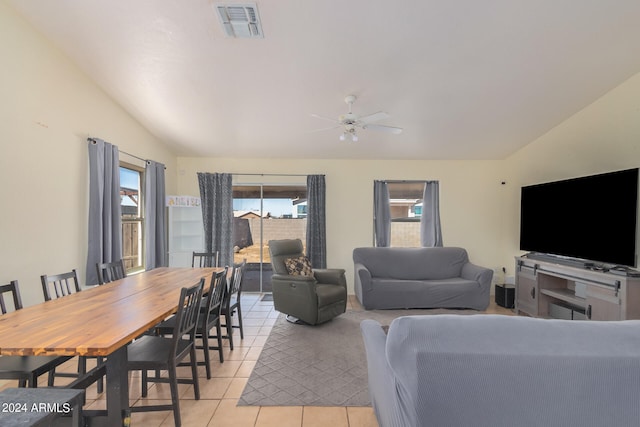 living room featuring ceiling fan, vaulted ceiling, and light tile patterned floors