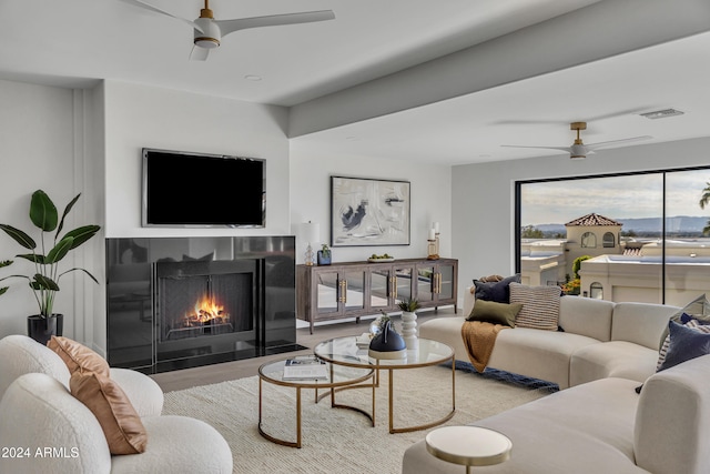 living room featuring hardwood / wood-style flooring and ceiling fan