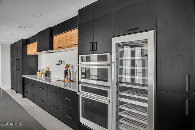 3800 E Lincoln Dr Unit 42, Phoenix, AZ 85018 - kitchen featuring dark cabinets, wine cooler, light countertops, modern cabinets, and double oven
