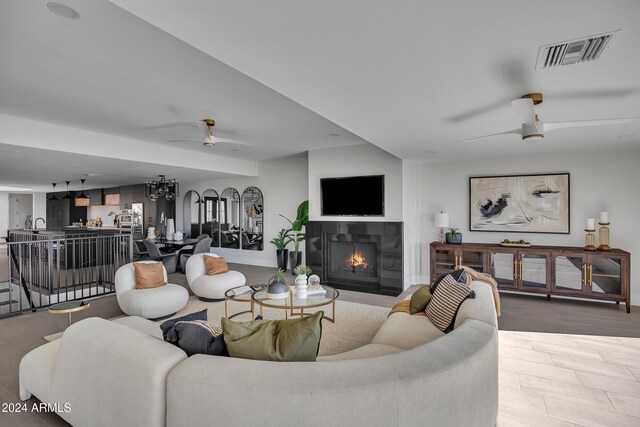 3800 E Lincoln Dr Unit 42, Phoenix, AZ 85018 - living area featuring ceiling fan, a lit fireplace, and baseboards