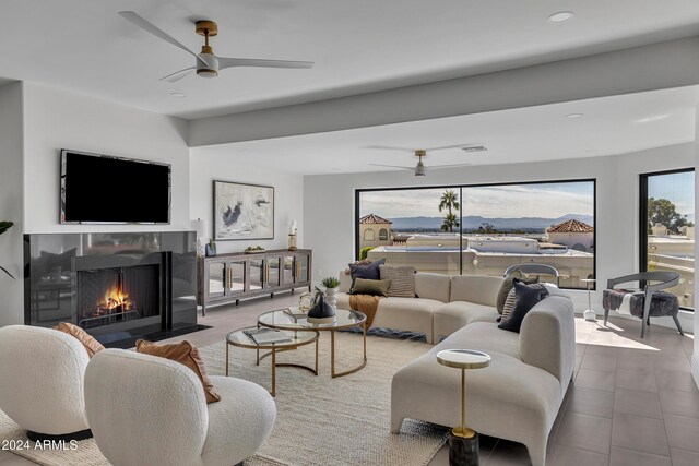 3800 E Lincoln Dr Unit 42, Phoenix, AZ 85018 - living room featuring ceiling fan, a fireplace with flush hearth, and recessed lighting