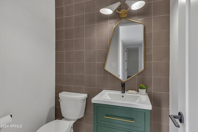 3800 E Lincoln Dr Unit 42, Phoenix, AZ 85018 - bathroom with tile walls, toilet, and vanity