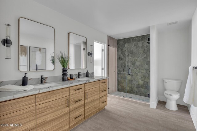 3800 E Lincoln Dr Unit 42, Phoenix, AZ 85018 - full bath with a stall shower, toilet, double vanity, and tile patterned floors