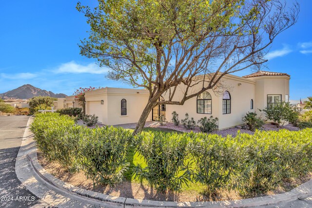 3800 E Lincoln Dr Unit 42, Phoenix, AZ 85018 - view of front facade with an attached garage, stucco siding, and a mountain view