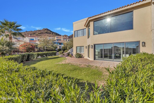 3800 E Lincoln Dr Unit 42, Phoenix, AZ 85018 - rear view of property featuring stucco siding and a yard