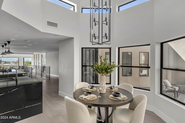 3800 E Lincoln Dr Unit 42, Phoenix, AZ 85018 - dining area with a high ceiling, baseboards, healthy amount of natural light, and recessed lighting