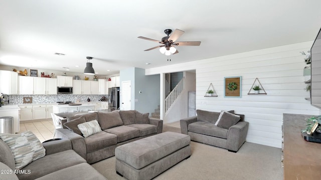 living room with ceiling fan and sink