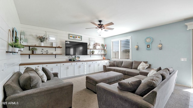 living room with light carpet and ceiling fan