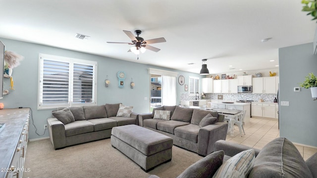 living room featuring ceiling fan and light tile patterned floors