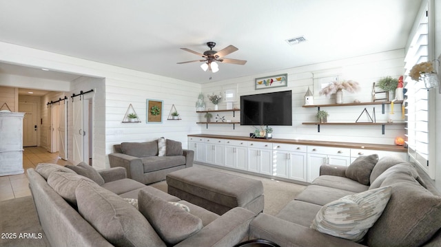 tiled living room with ceiling fan