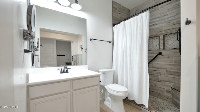 bathroom featuring tile patterned floors, curtained shower, vanity, and toilet