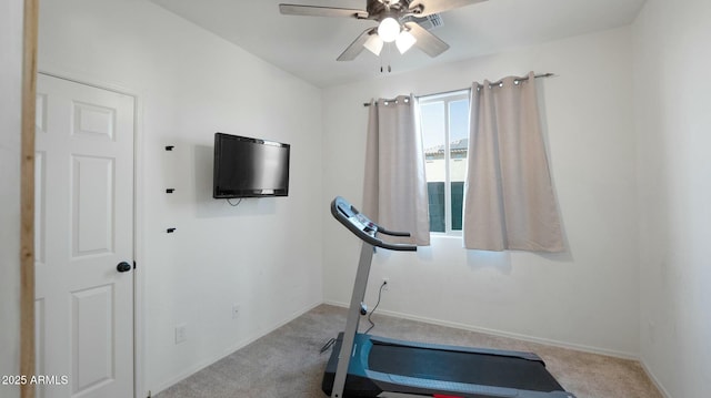 exercise area with ceiling fan and light colored carpet