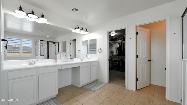 bathroom featuring vanity, tile patterned floors, and a shower with shower door