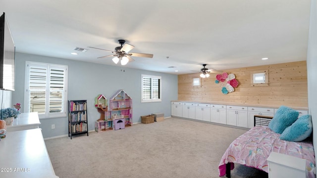 recreation room with wood walls and light carpet