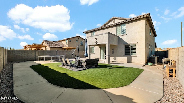 back of house featuring a yard, a patio, and central air condition unit