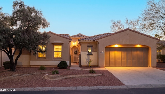 mediterranean / spanish home featuring a garage