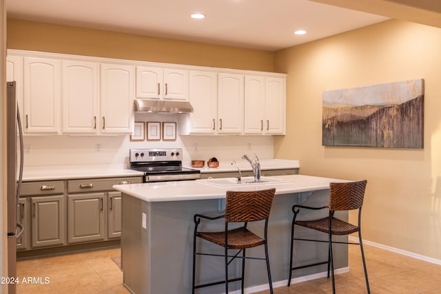 kitchen featuring a kitchen island with sink, sink, white cabinetry, and stainless steel appliances