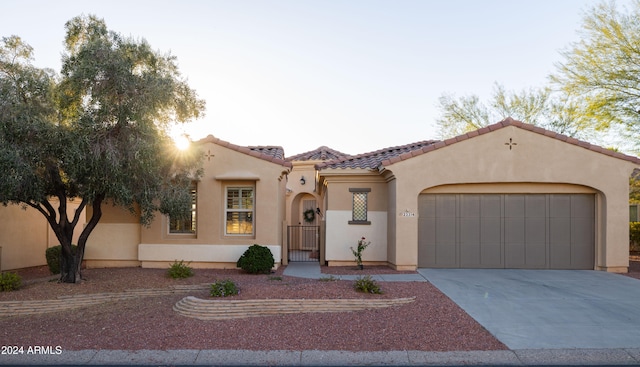 mediterranean / spanish house featuring a garage