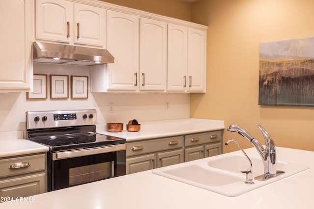 kitchen with stainless steel electric stove, white cabinetry, sink, and gray cabinetry