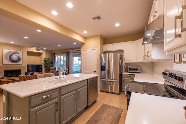 kitchen featuring gray cabinetry, appliances with stainless steel finishes, sink, white cabinetry, and a kitchen island with sink