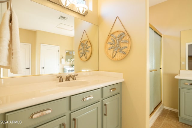 bathroom with vanity, tile patterned flooring, and an enclosed shower