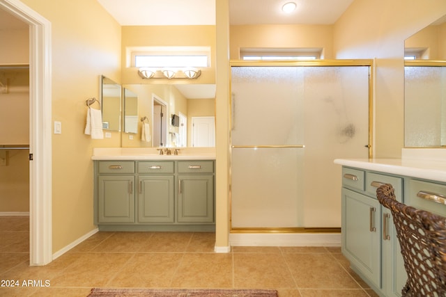 bathroom with vanity, walk in shower, and tile patterned flooring