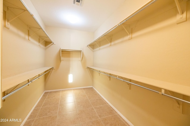 walk in closet with tile patterned floors