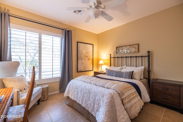 bedroom with ceiling fan and light tile patterned flooring