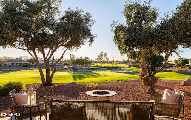 view of community featuring a yard and a fire pit