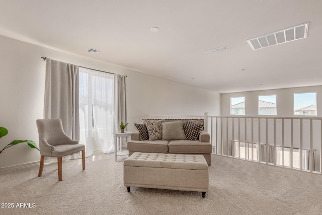 sitting room featuring light colored carpet