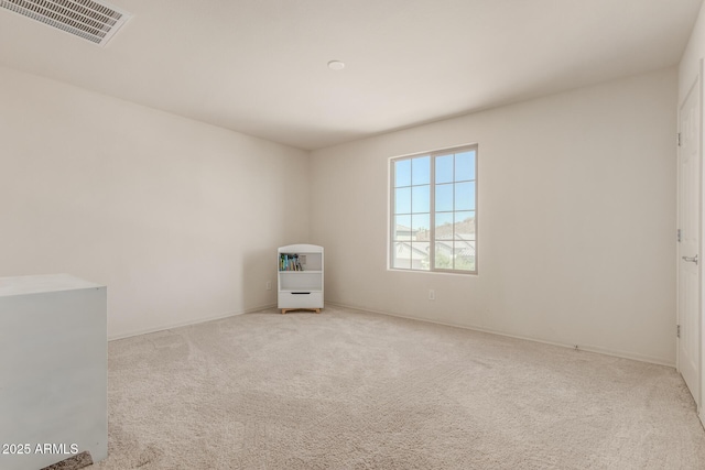 unfurnished room with light carpet