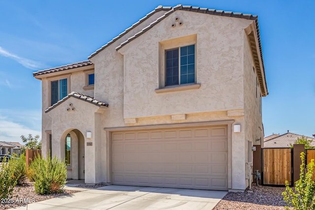 mediterranean / spanish-style house with a garage