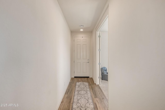 hall with light hardwood / wood-style flooring