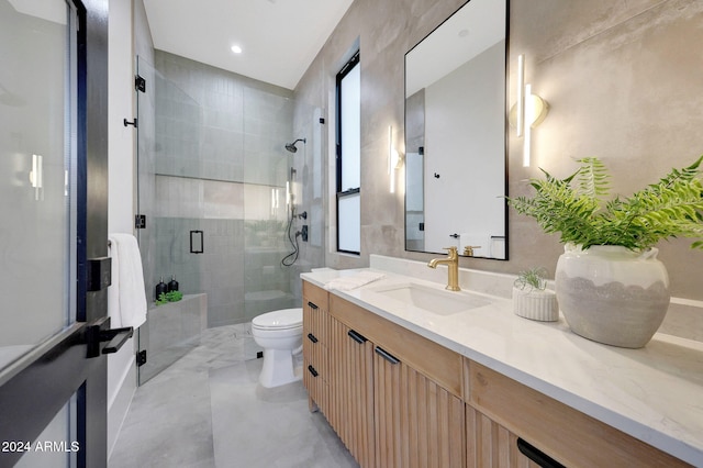 bathroom featuring a healthy amount of sunlight, vanity, toilet, and walk in shower