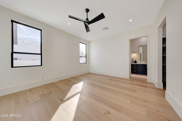 empty room featuring light hardwood / wood-style flooring and ceiling fan