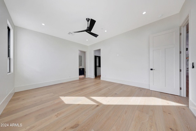 spare room featuring light hardwood / wood-style floors and ceiling fan