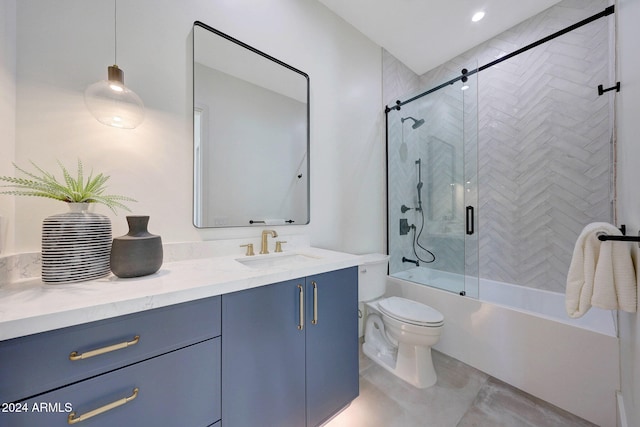 full bathroom featuring vanity, bath / shower combo with glass door, and toilet