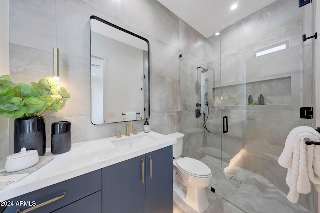 bathroom featuring vanity, an enclosed shower, toilet, and tile walls