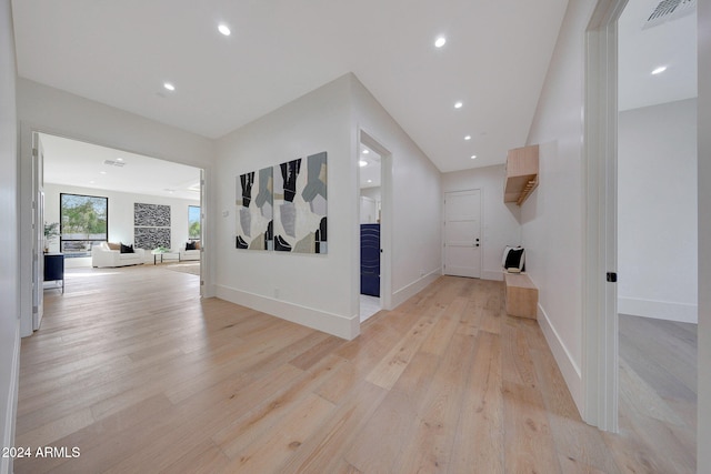 corridor with light hardwood / wood-style floors